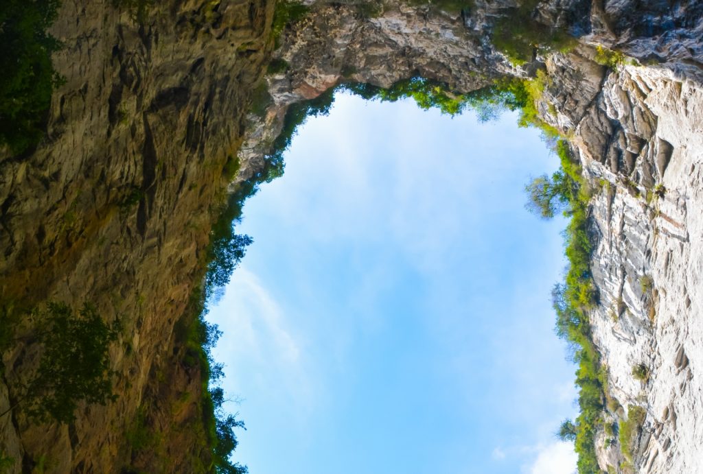 The view of Qinglong Bridge from the bottom of Shenying Tiankeng (Divine Eagle Sinkhole)