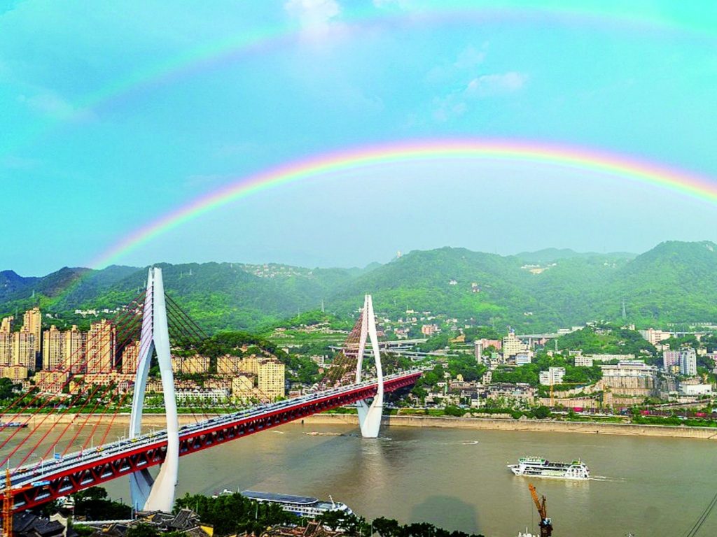 After the rain, the sky cleared, revealing a double rainbow.