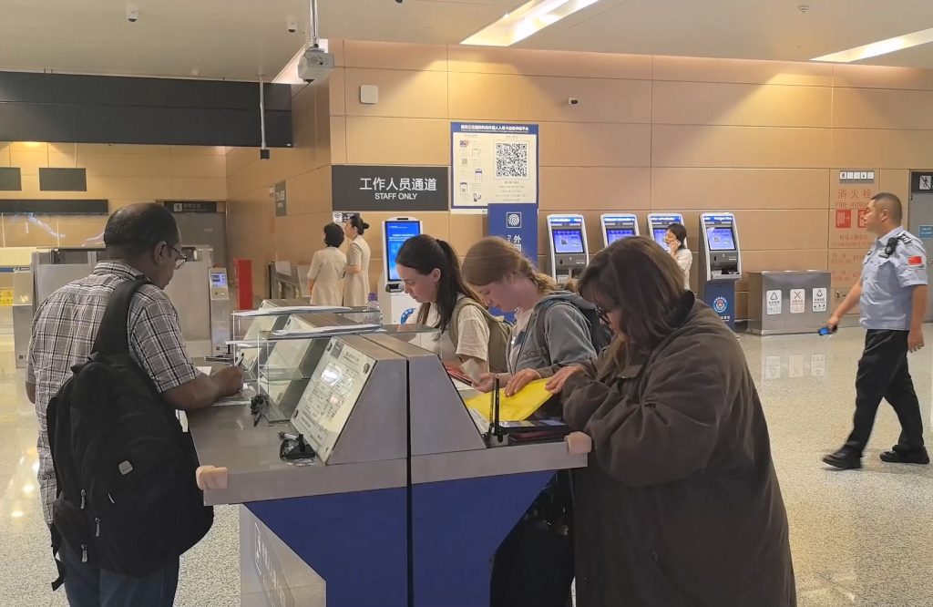 International tourists fill out entry cards at Chongqing Jiangbei International Airport.