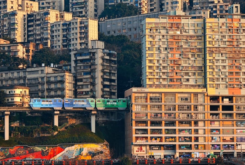 A monorail train passing directly through a residential building.