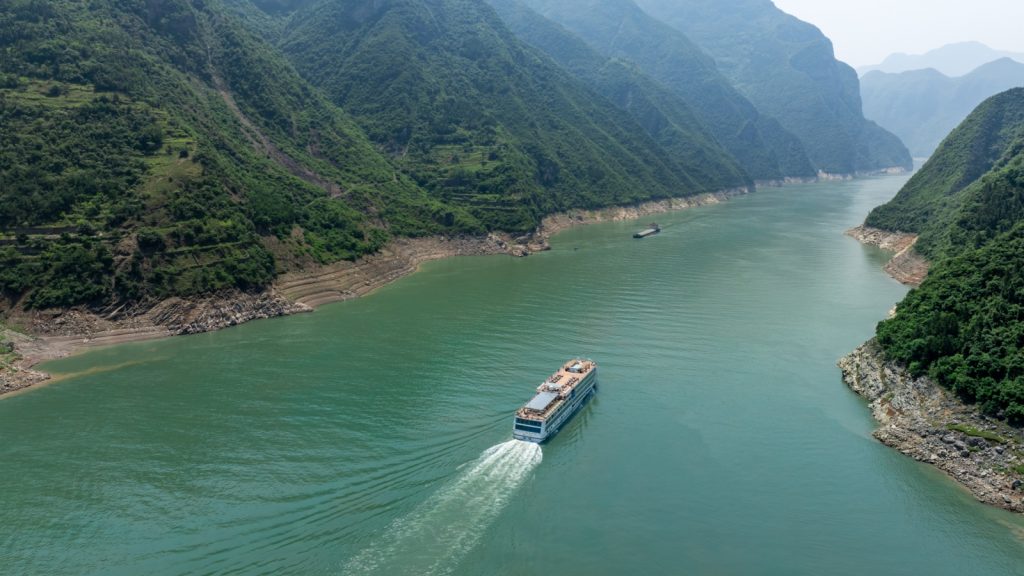 A cruise ship sails through the magnificent Three Gorges of the Yangtze River.